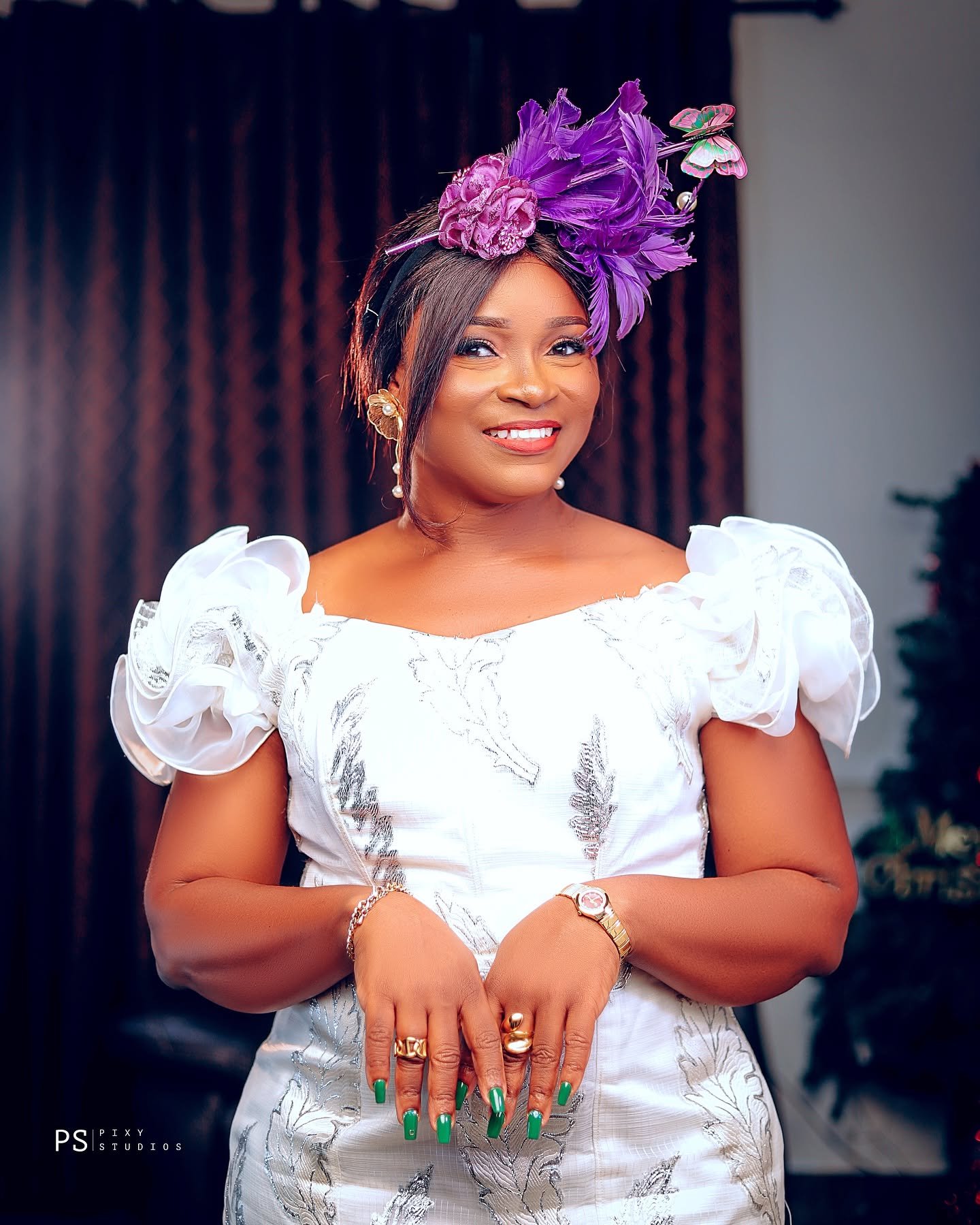 Client portrait with purple feather fascinator